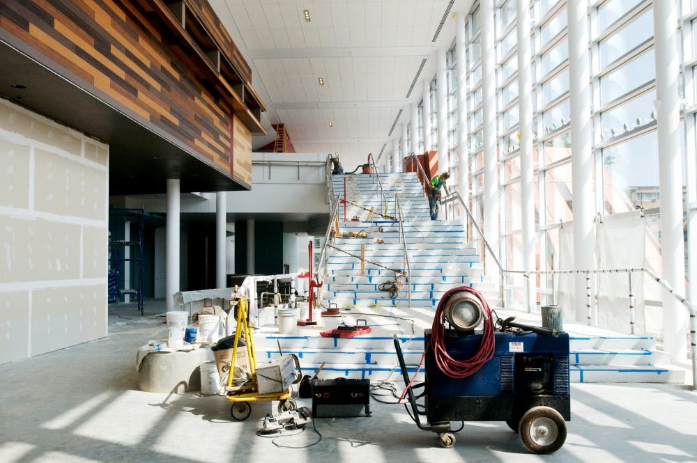 <p>Construction on the grand staircase in Brody Hall continues Friday, Aug. 13, as workers finish phase one of renovations. State News File Photo</p>