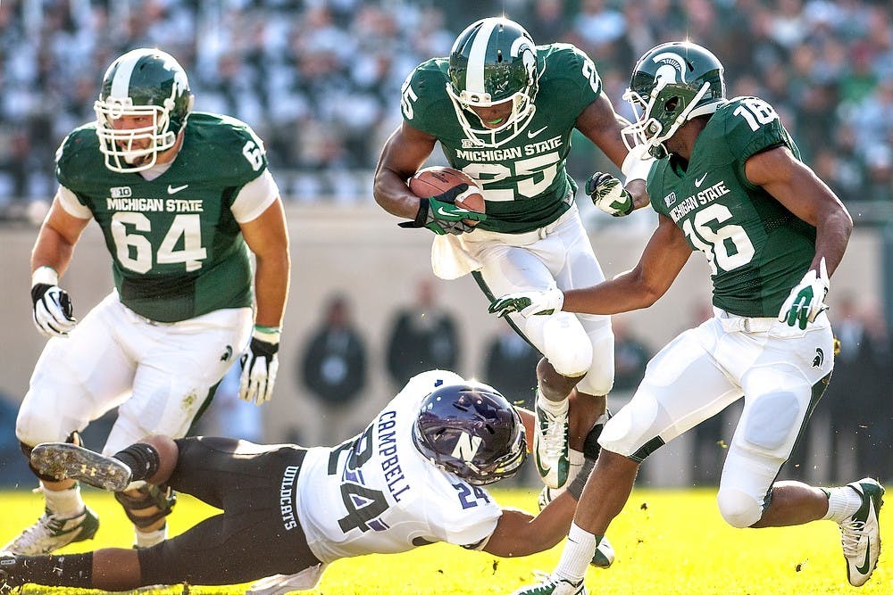 	<p>Sophomore wide receiver Keith Mumphery, No. 25, runs with the ball before being stopped by Northwestern defensive back Ibraheim Campbell. Next to Mumphery is offensive guard Blake Treadwell, No. 64, and freshman wide receiver Aaron Burbridge. The Spartans fell to the Wildcats, 23-20, Nov. 17, 2012, at Spartan Stadium during senior day. Justin Wan/The State News</p>