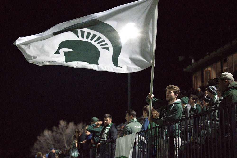 <p>The Spartan student section sported flags bearing green and white to support the Women&#x27;s Soccer Team on Nov. 11, 2022. The Spartans won 3-2 in double overtime﻿.</p>