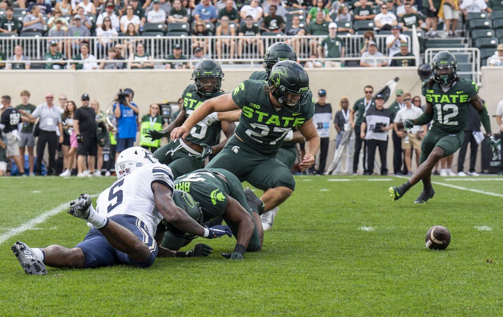 Redshirt sophomore linebacker Cal Haladay, 27, turns to pick up the Akron fumble during Michigan State’s game against the Zips on Sat., Sept. 10, 2022 at Spartan Stadium.