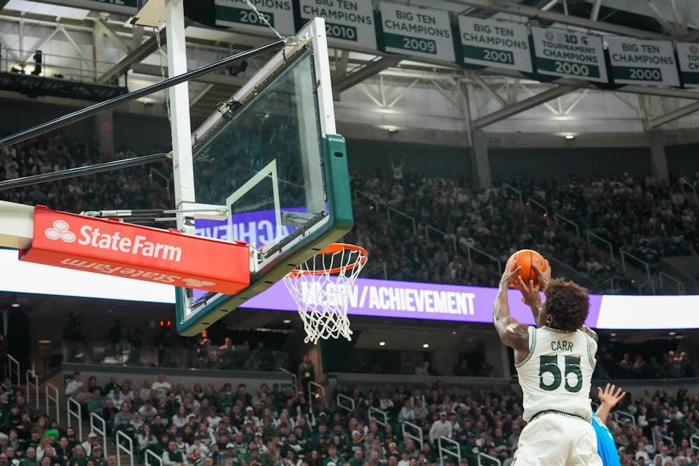 Michigan State junior Coen Carr (55) dunks the ball against UCLA at the Breslin Center in East Lansing, Michigan, on Tuesday, Feb. 17, 2026.