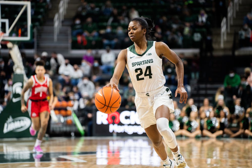 <p>Senior guard Nia Clouden (24) dribbles against Ohio State University at the Breslin Center on Feb. 27, 2022.</p>