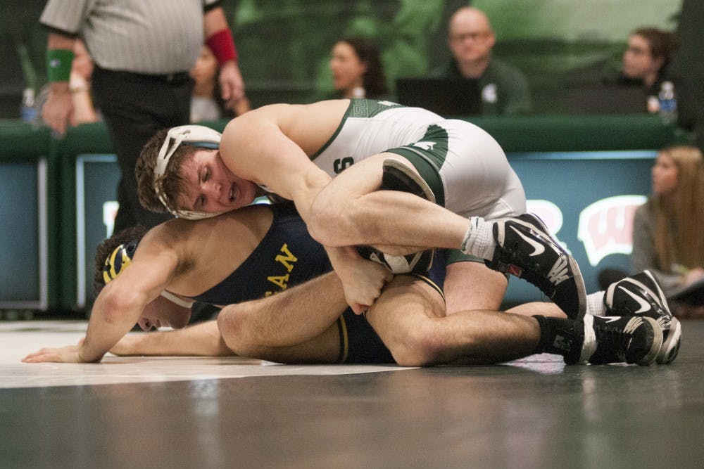 Senior 149-pounder Nick Trimble fights Wolverines 149-pounder Malik Amine during Senior Day on Feb. 5, 2017 at Jenison Field House. The Spartan wrestlers were defeated by the Wolverines, 24-15. 