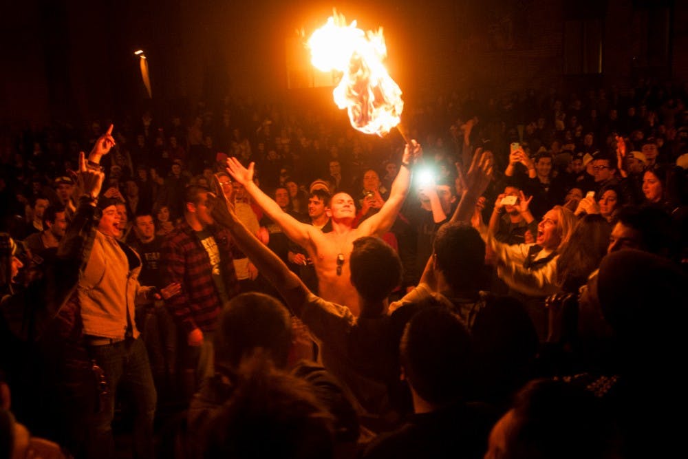 	<p>Students gather in the streets of Cedar Village after an <span class="caps">MSU</span> victory in the Big Ten Championship game on Dec. 8, 2013. The police and fire department responded to multiple fires across East Lansing.</p>