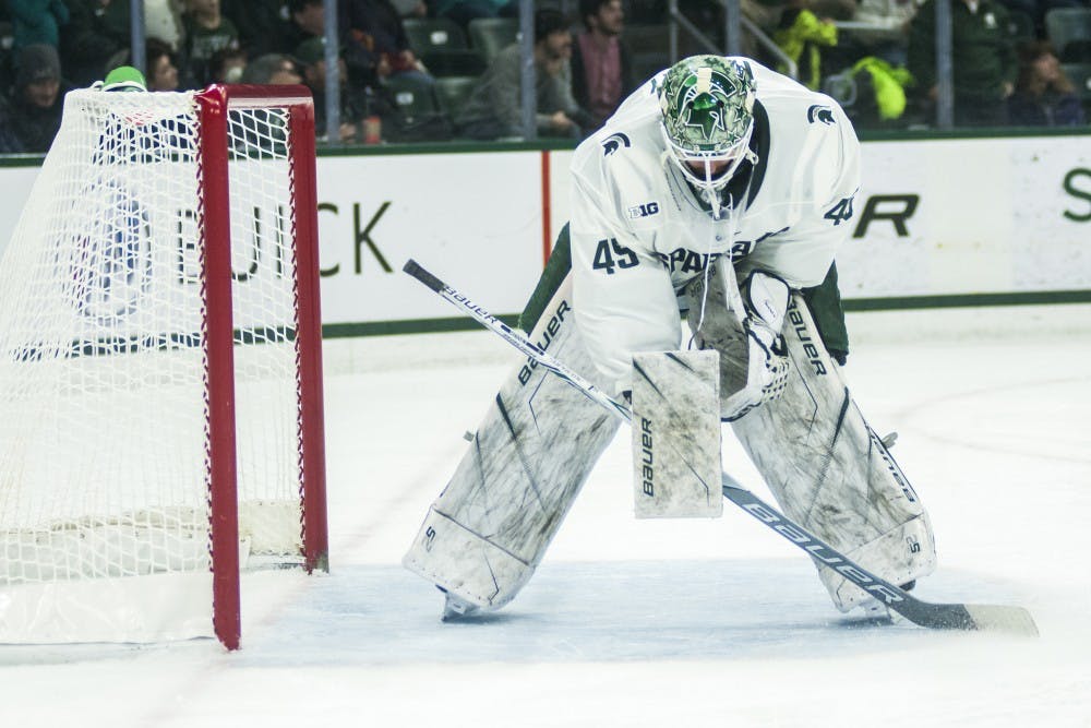 Senior goaltender Ed Minney (45) stretches during the men's hockey game against Ohio State on Jan. 5, 2018 at the Munn Ice Arena. The Spartans were defeated by the Buckeyes, 4-1. (Annie Barker | The State News)