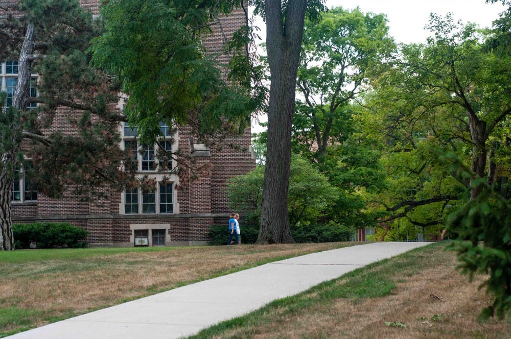 People walk near Beaumont Tower on July 30, 2018.