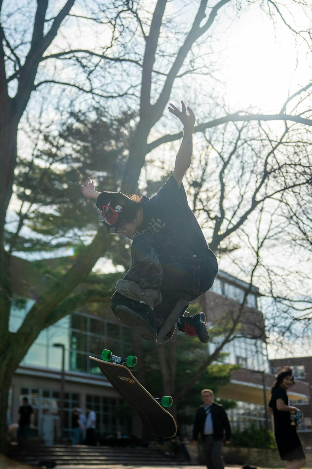 A member of MSU Skate Club catches air while performing a trick outside of Shaw Hall on Michigan State University’s campus in East Lansing, Mich., on March 20, 2026.