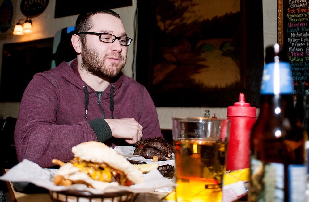 	<p>Williamston, Mich., resident Christopher Cullen enjoys beer and a burger Monday at the Peanut Barrel Restaurant, 521 E. Grand River Ave. The East Lansing City Council discussed liquor license renewals at the work session Wednesday, Feb. 26, 2013, at City Hall, 410 Abbot Road. </p>