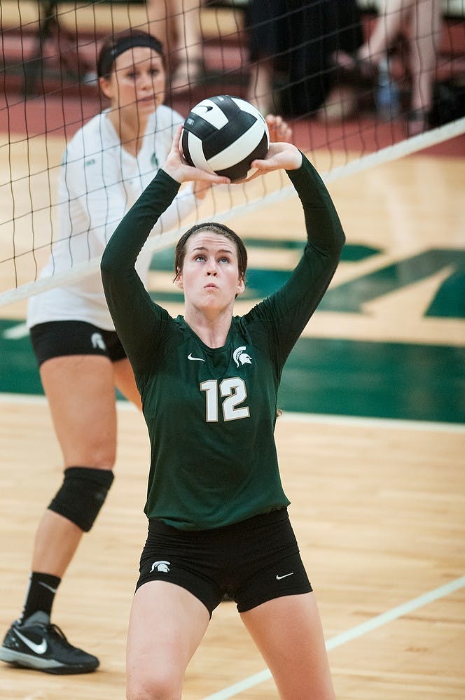 	<p>Senior setter Kristen Kelsay sets the ball during the Green and White match, Aug. 24, 2013, at Jenison Field House. White team won the scrimmage, 2-1.  Danyelle Morrow/The State News</p>