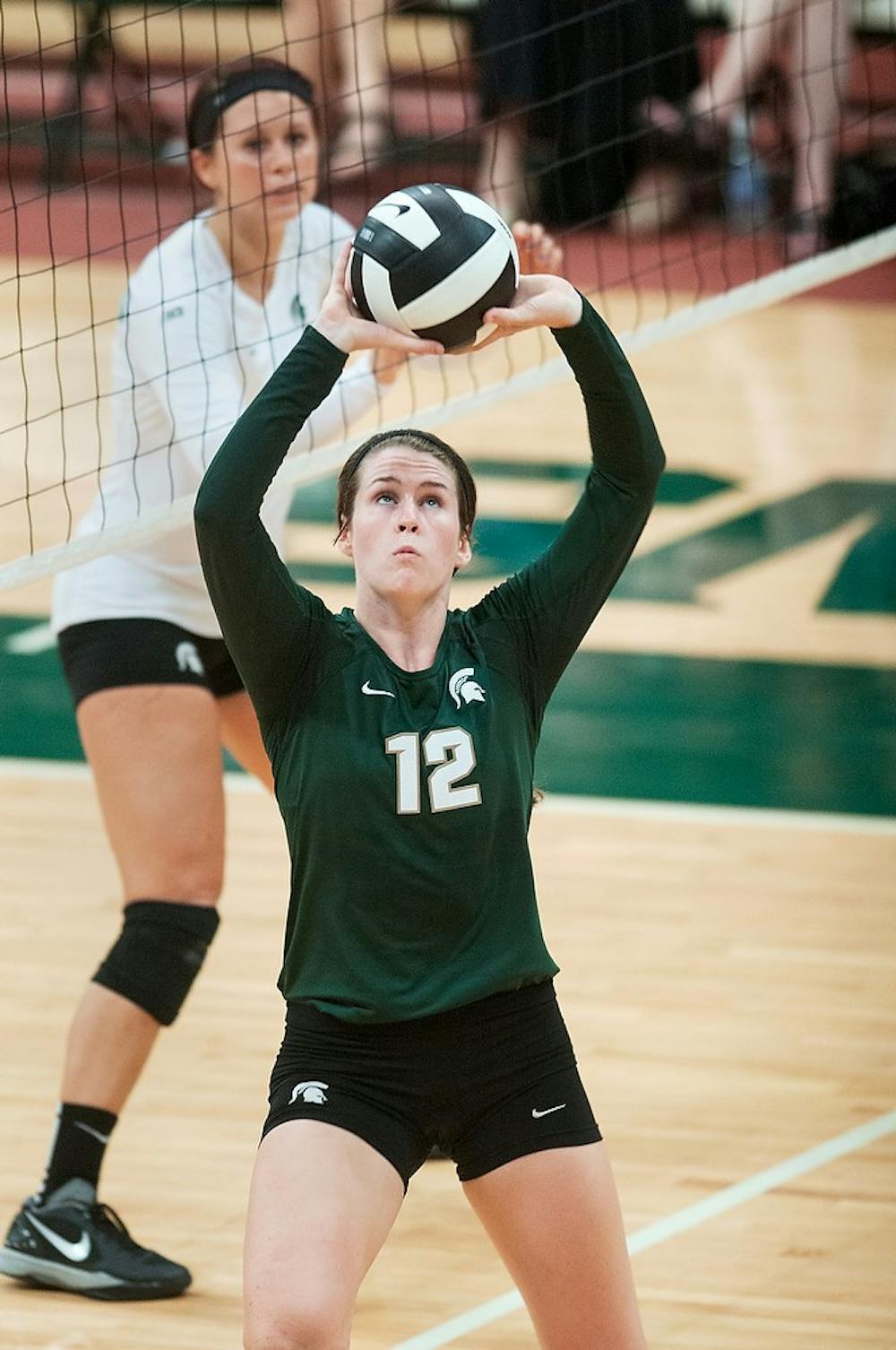 	<p>Senior setter Kristen Kelsay sets the ball during the Green and White match, Aug. 24, 2013, at Jenison Field House. White team won the scrimmage, 2-1.  Danyelle Morrow/The State News</p>