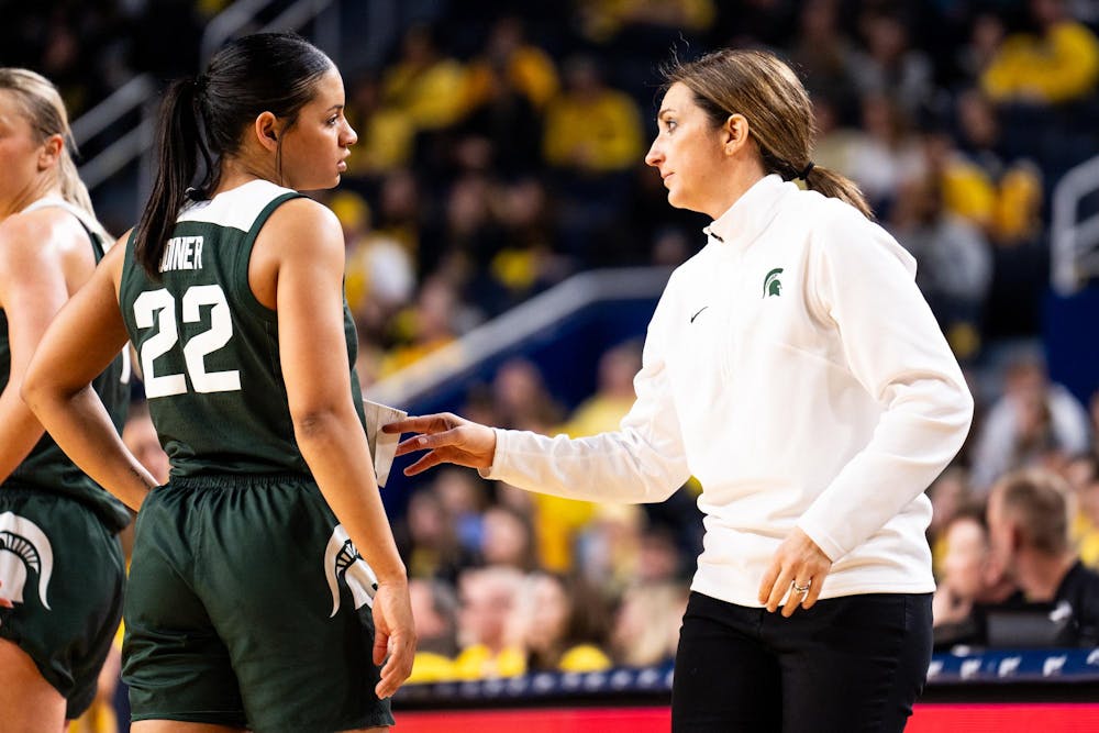 <p>Michigan State graduate student guard No. 22 Moira Joyner speaks with head coach Robyn Fralick at the Crisler center in Ann Arbor on Feb. 18, 2024. Michigan State secured a season sweep of the rival Wolverines, breaking a two-game losing streak in the process.</p>