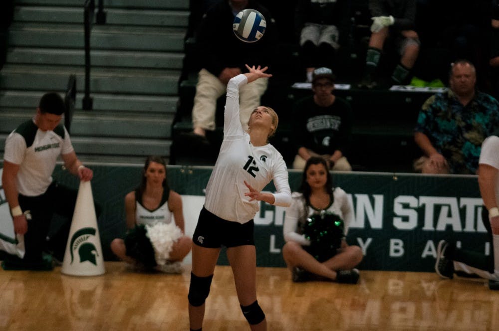 Junior setter Rachel Minarick (12) serves the ball during the game against Maryland on Oct. 8, 2016 at Jenison Field House.  The Spartans defeated the Terrapins, 3-1. 