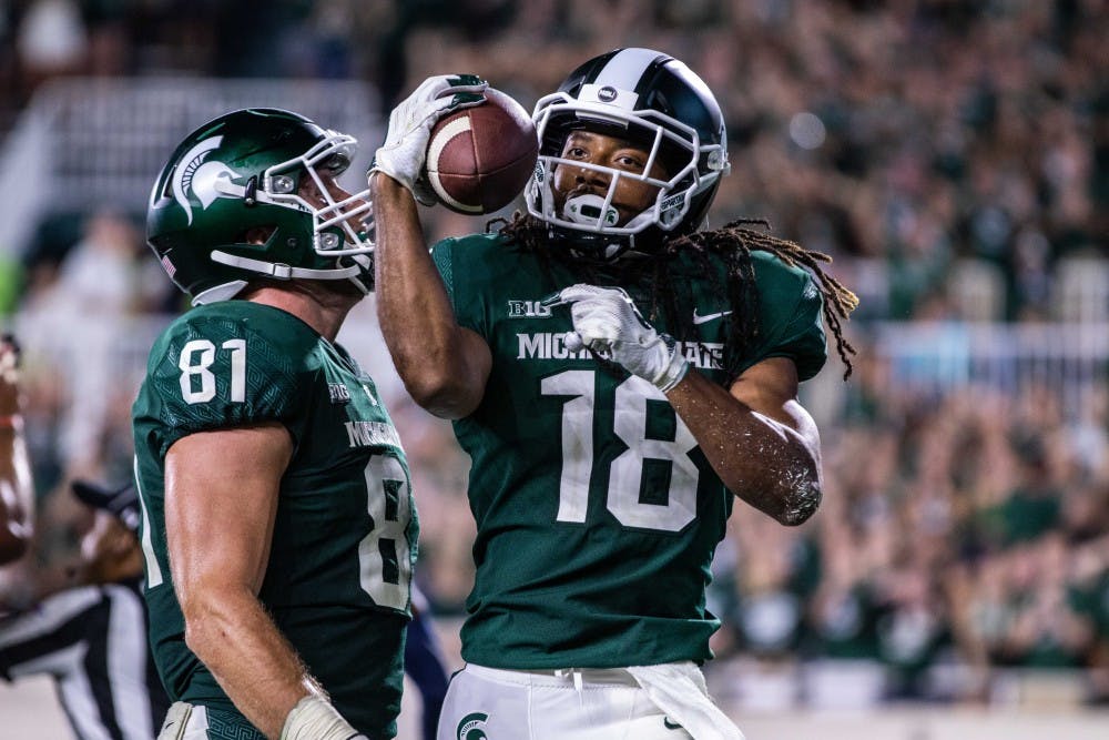 Senior wide receiver Felton Davis III (18) celebrates a reception for a two-point conversion during the game against Utah State on Aug. 31 at Spartan Stadium. The Spartans defeated the Aggies, 38-31.