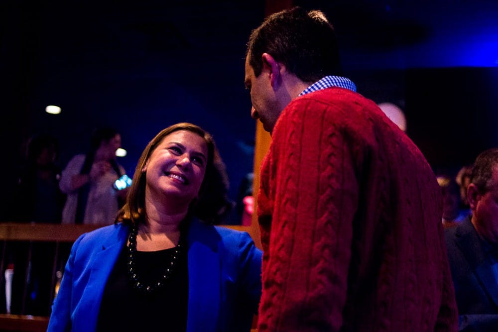 Elissa Slotkin smiles at Oakland County Treasurer Andy Meisner during Michigan Congressional candidate Elissa Slotkin's watch party on Nov. 6, 2018 at the Deer Lake Athletic Club in Clarkston.