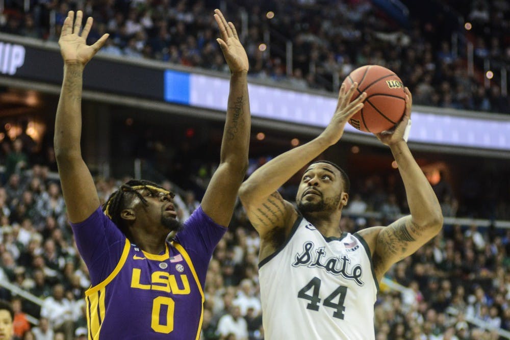 Junior forward Nick Ward (44) jumps with the ball against LSU’s forward Naz Reid (0) during the game against LSU at Capital One Arena on March 29, 2019. The Spartans defeated the Tigers, 80-63.