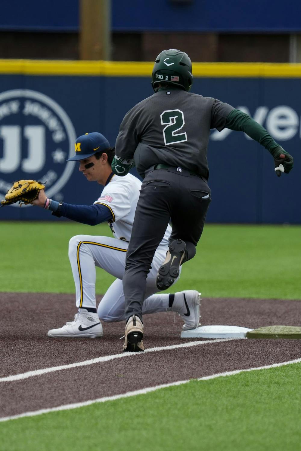 Michigan State senior outfielder JT Sokolove (2) runs down the first baseline before getting out on April 26, 2026. The Spartans lost to the Wolverines in the second game 9-2. 