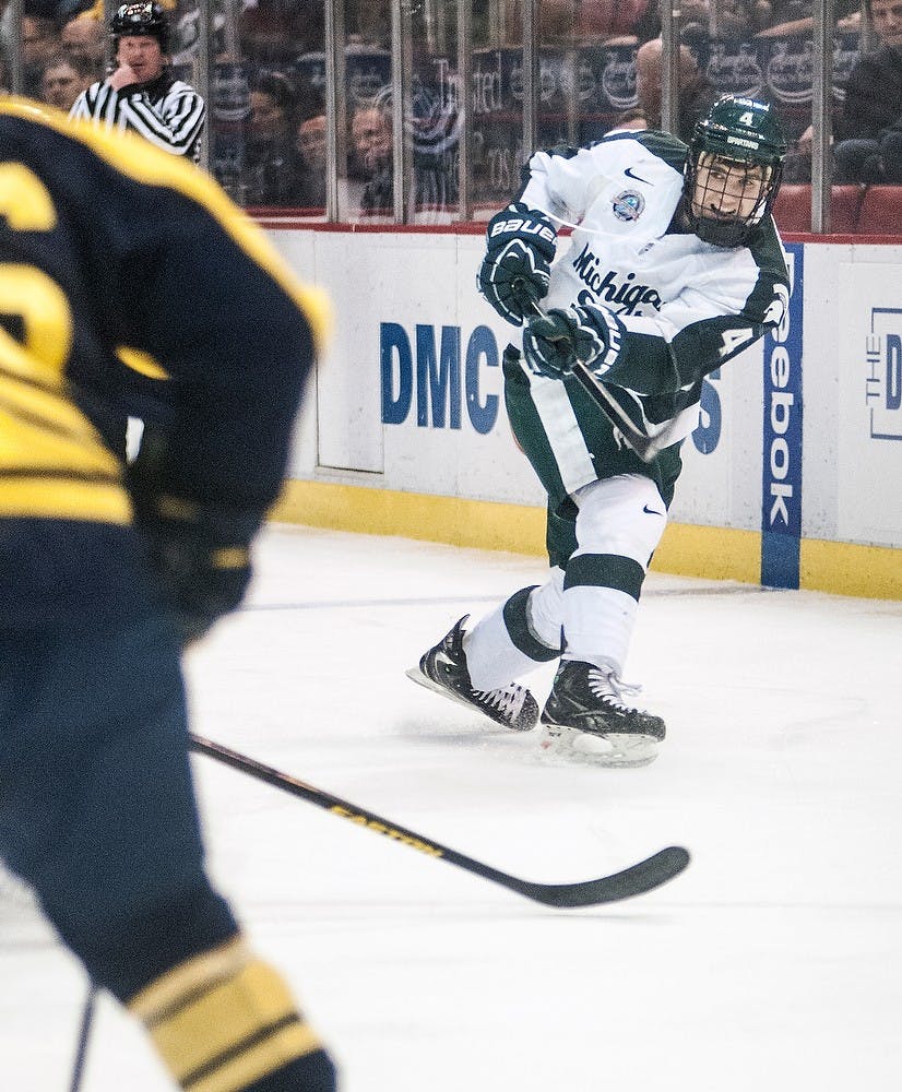 	<p>Freshman defenseman Travis Walsh takes a slap shot against Michigan on Saturday, Feb. 2, 2013, at Joe Louis Arena in Detroit. The Wolverines defeated the Spartans, 5-2, in the second game of the weekend series. Adam Toolin/The State News</p>