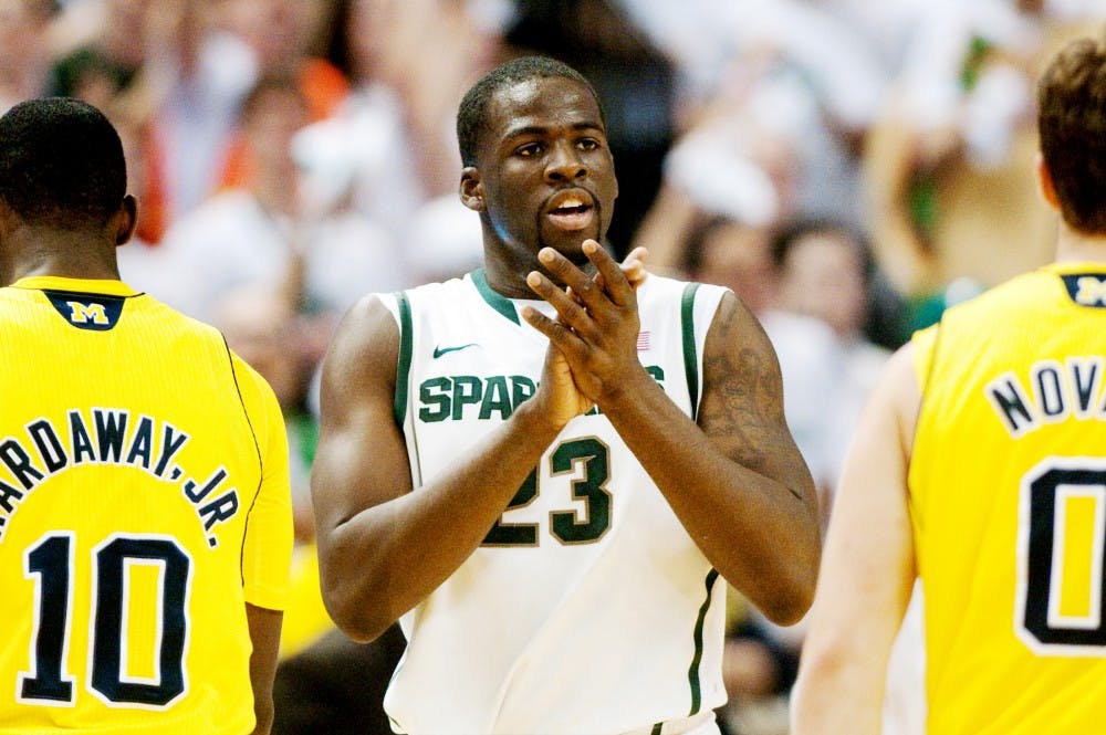 Senior forward Draymond Green claps during a break in play Sunday afternoon at Breslin Center. Green led the Spartans in scoring with 14 points during the 64-54 victory over Michigan. Matt Hallowell/The State News