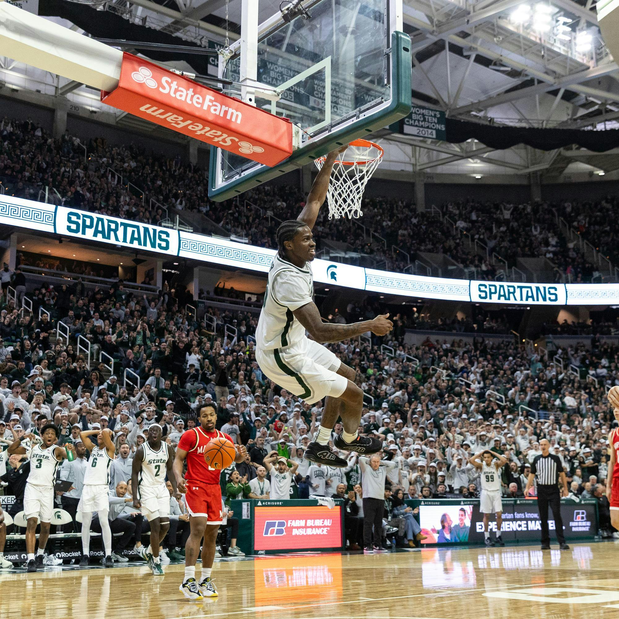 MSU Jr. F, Coen Carr (55), hangs from the net after a dunk in the Breslin Center in East Lansing, MI on Jan. 24, 2026.