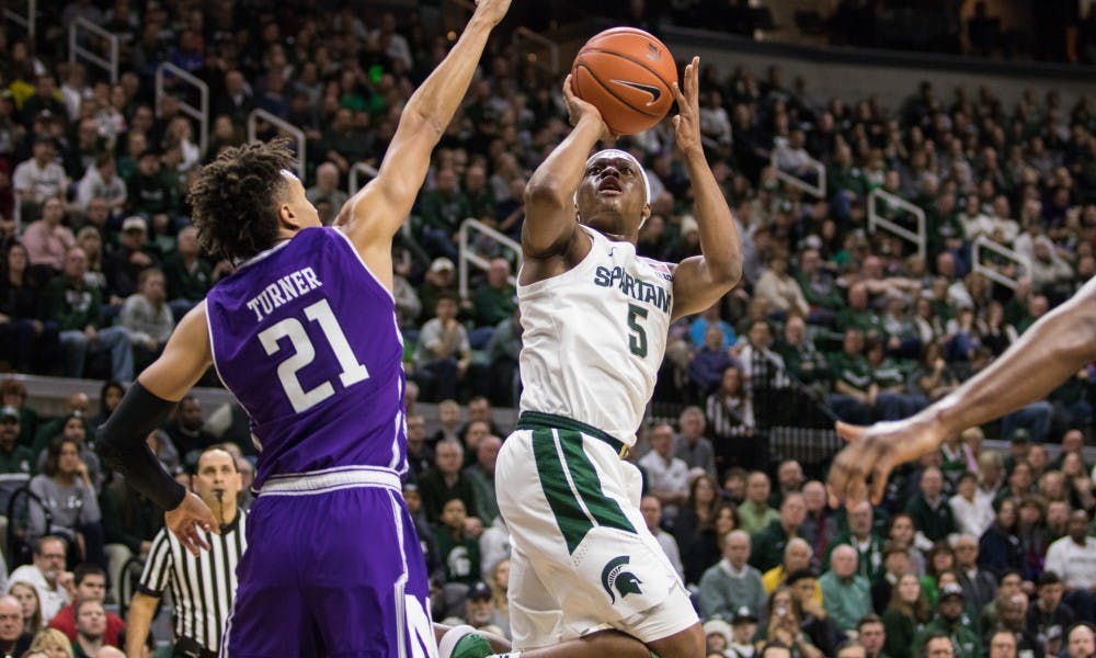 Junior guard Cassius Winston (5) takes a shot during the game against Northwestern University at Breslin Center on Jan. 2, 2019. The Spartans led the Wildcats, 52-32 at the half.