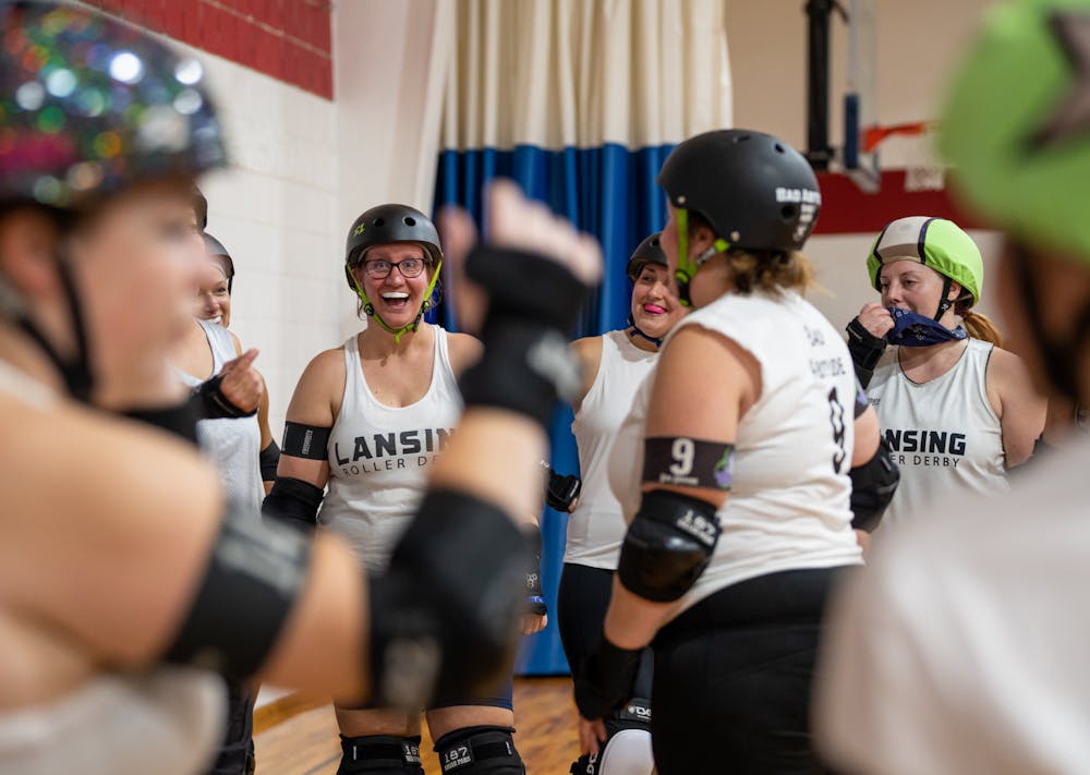 <p>The Lansing roller derby team shares a laugh between scrimmages on Sept. 22, 2022.</p>