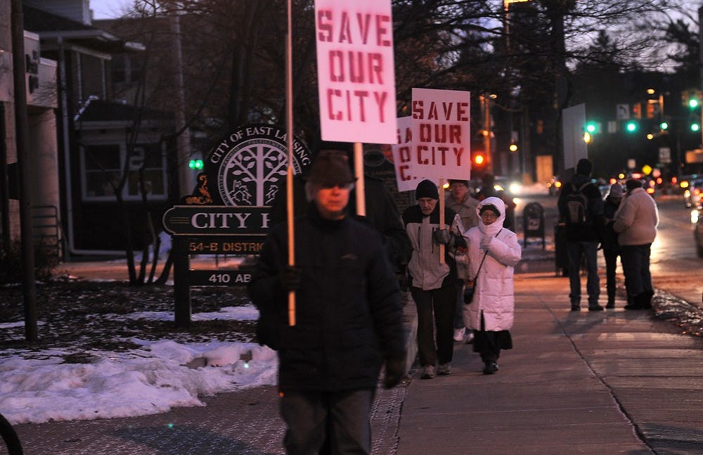 <p>East Lansing residents protest Jan. 25, 2015, at East Lansing City Hall, 410 Abbot Rd. Citizens marched in response to the council decision to close the both Bailey Child Care and Bailey Community Centers. Alice Kole/The State News </p>