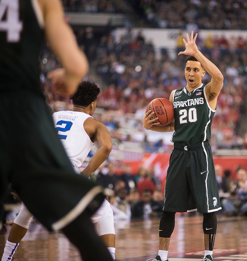 <p>Senior guard Travis Trice signals to his teammates April 4, 2015, during the semifinal game of the NCAA Tournament in the Final Four round at Lucas Oil Stadium in Indianapolis, Indiana. The Spartans were defeated by the Blue Devils, 81-61. Erin Hampton/The State News</p>