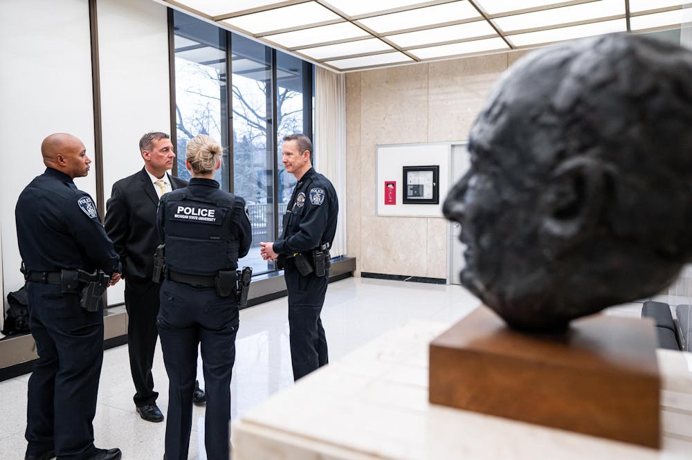 <p>Michigan State University Chief of Police Mike Yankowski, Deputy Chief Chris Rozman, and officers discuss the process of arresting the remaining Hurriya Coalition and MSU Sunrise members protesting in the lobby of the Hannah Administration Building in East Lansing, Michigan on April 11, 2025.</p>