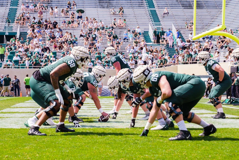 MSU football players line up for a drill during the spring open practice, held at Spartan Stadium on April 15, 2023.
