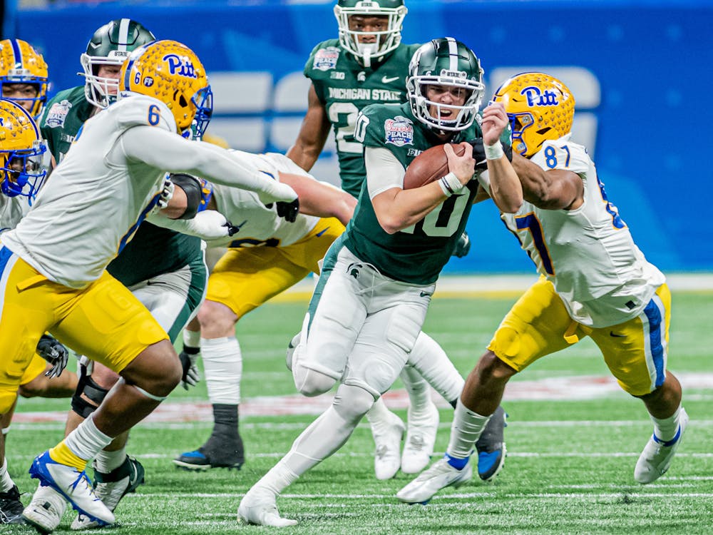 <p>Redshirt sophomore quarterback Payton Thorne runs through tackles during the Spartans 31-21 victory against Pitt in the Chick-Fil-A Peach Bowl on Dec. 30, 2021.</p>