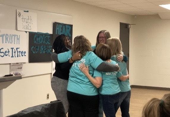 Sister survivors embrace following vote to release Nassar documents on Dec. 15, 2023. 