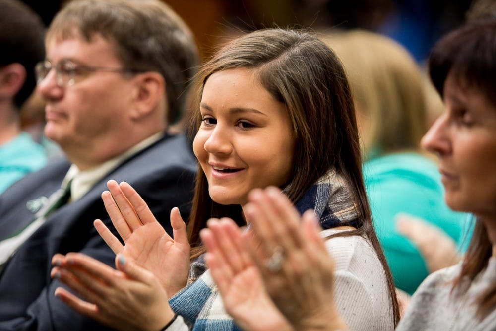 Kaylee Lorincz smiles and claps during a Board of Trustees meeting on Jan. 13, 2019 at the Hannah Administration Building after announcing the  Satish Udpa was named the new interim president. "I felt like I could finally take that sigh of relief I was waiting for," said Lorincz. 