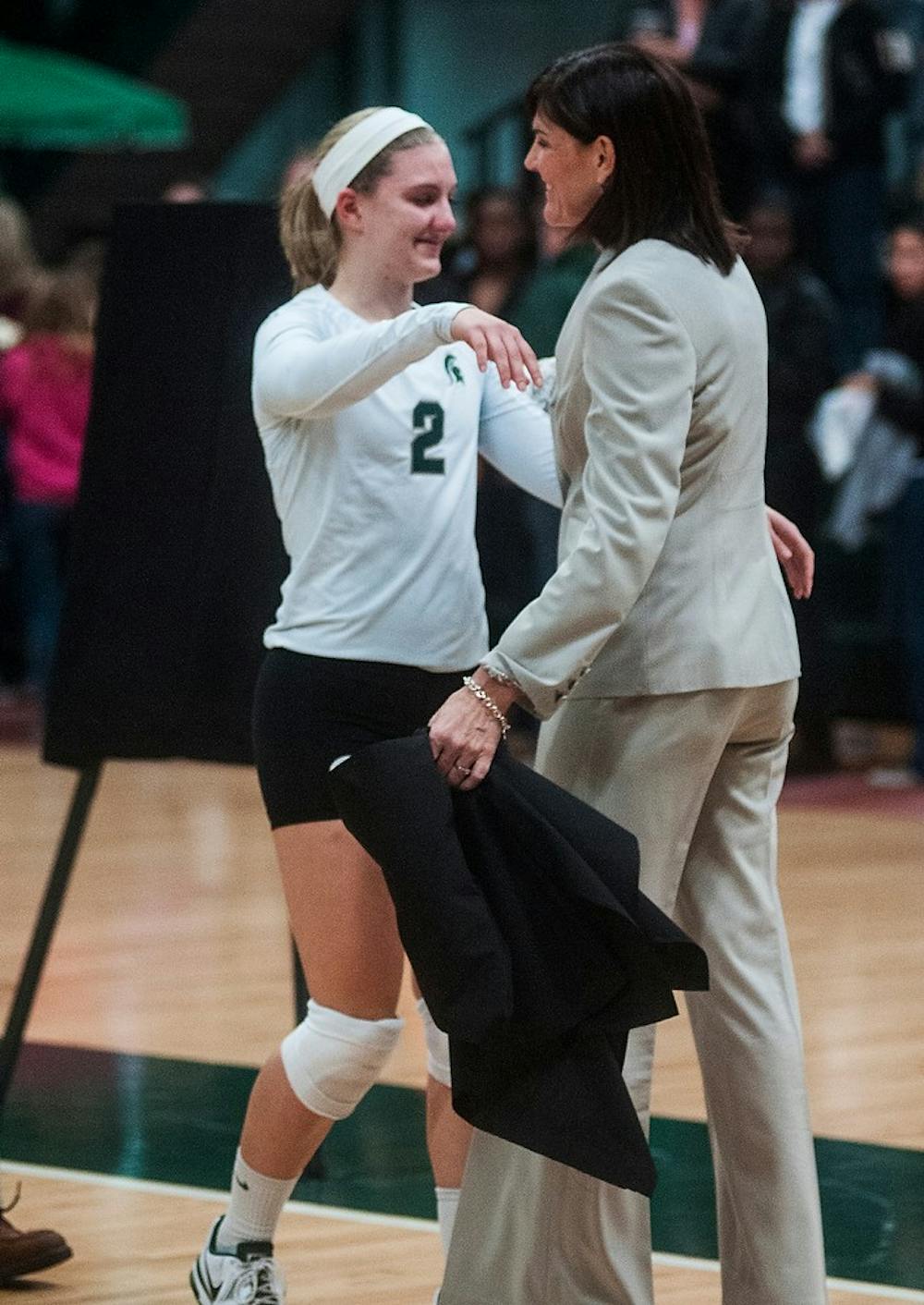 	<p>Senior defensive specialist Chelsey Probst hugs head coach Cathy George on senior night after the game Wednesday, Nov. 21, 2012, at Jenison Field House. The Spartans fell to the Wolverines in three straight sets. Adam Toolin/The State News</p>