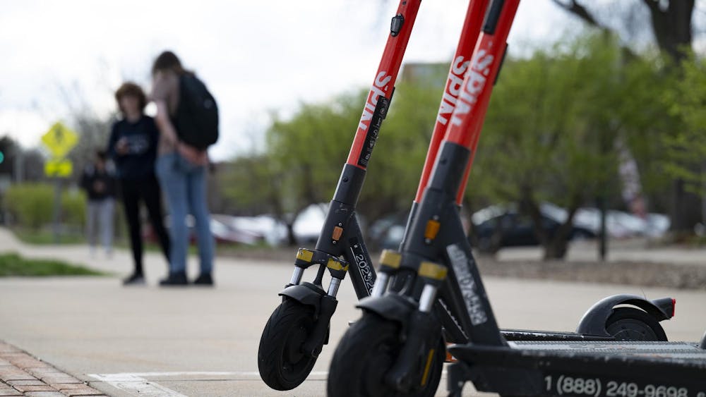 Scooters parked by the bus stop near Owen Graduate Hall at Michigan State University campus on April 14, 2025