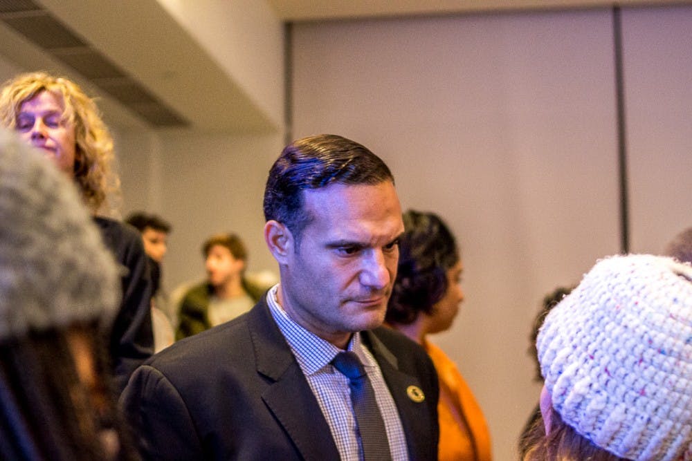 <p>Board member Brian Mosallam listens to a student after the town hall meeting on Feb. 1, 2018 at Kellogg Center. &nbsp;The town hall brought together students, staff and members of the MSU community to discuss the current climate of the campus. &nbsp;</p>