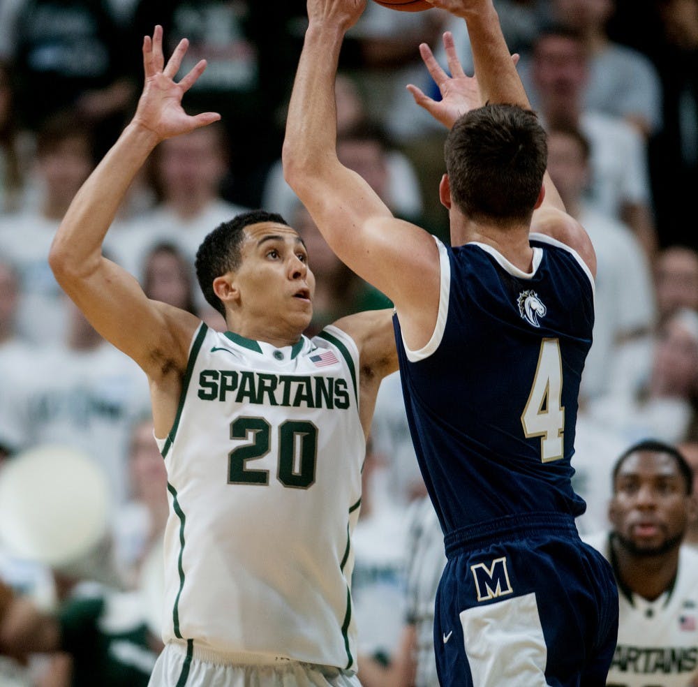 <p>Senior guard Travis Trice attempts to block the ball from Master's College guard Reid Shackelford Nov. 3, 2014, during the game at Breslin Center. The Spartans defeated the Mustangs, 97-56. Raymond Williams/The State News</p>