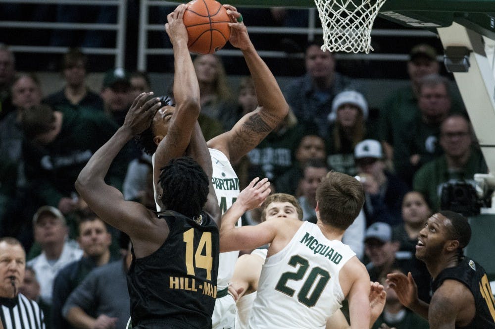 Freshman forward Nick Ward (44) grabs the ball after Oakland forward Xavier Hill-Mais (14) attempts to shoot a basket the game against Oakland on Dec. 21, 2016 at Breslin Center. The Spartans defeated the Grizzlies, 77-65. 