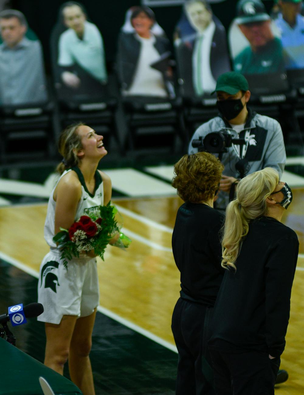 Senior Laurel Jacqmain (21) of the Michigan State Spartans watching videos that loved ones put together for her to view at Senior Night after the game against Wisconsin on Saturday, Mar. 6, 2021.