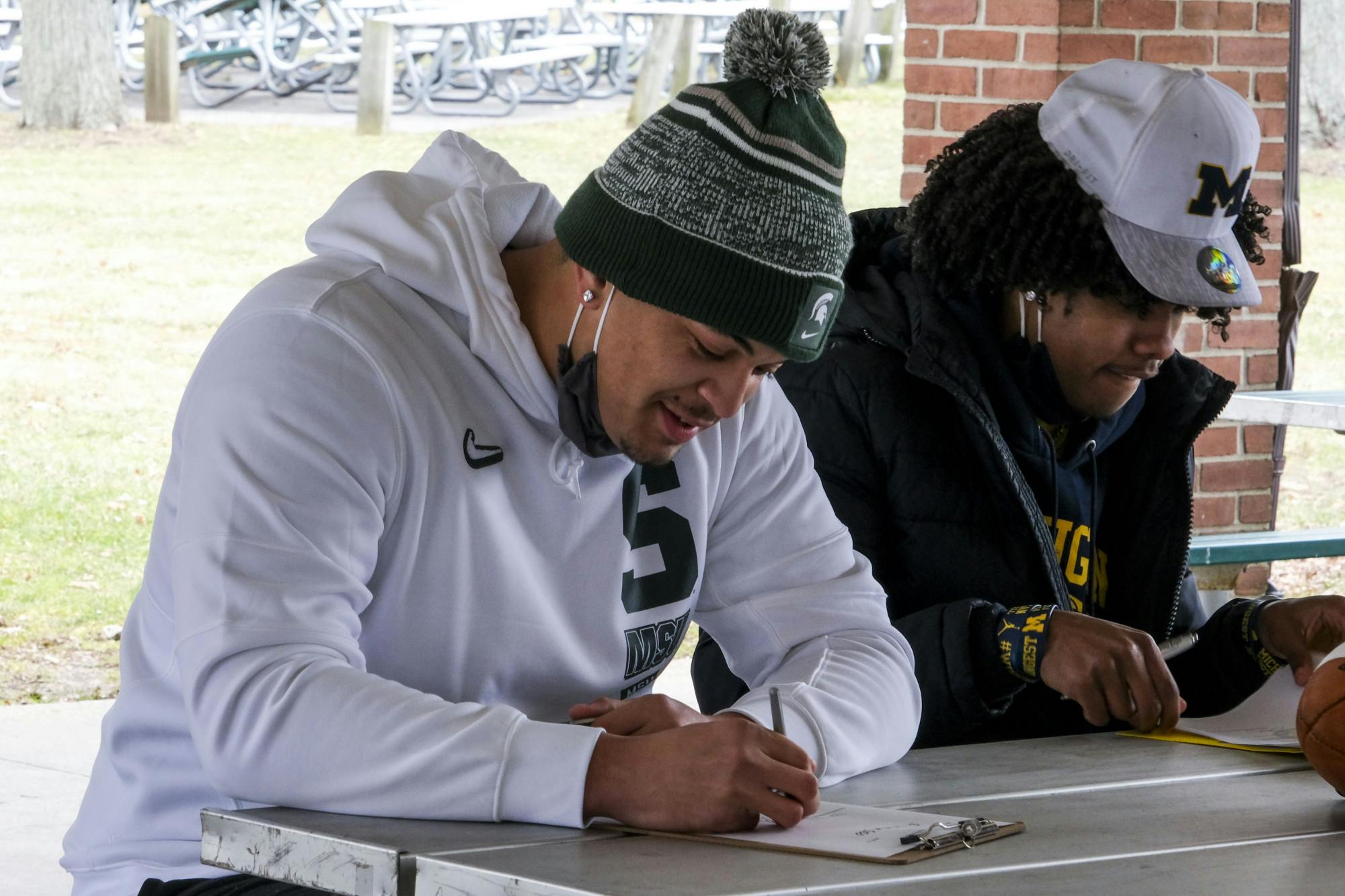 <p>MSU commit Ethan Boyd and U of M commit Andrel Anthony Jr. sign for their respective teams at Patriarche Park on Dec. 16, 2020.</p>
