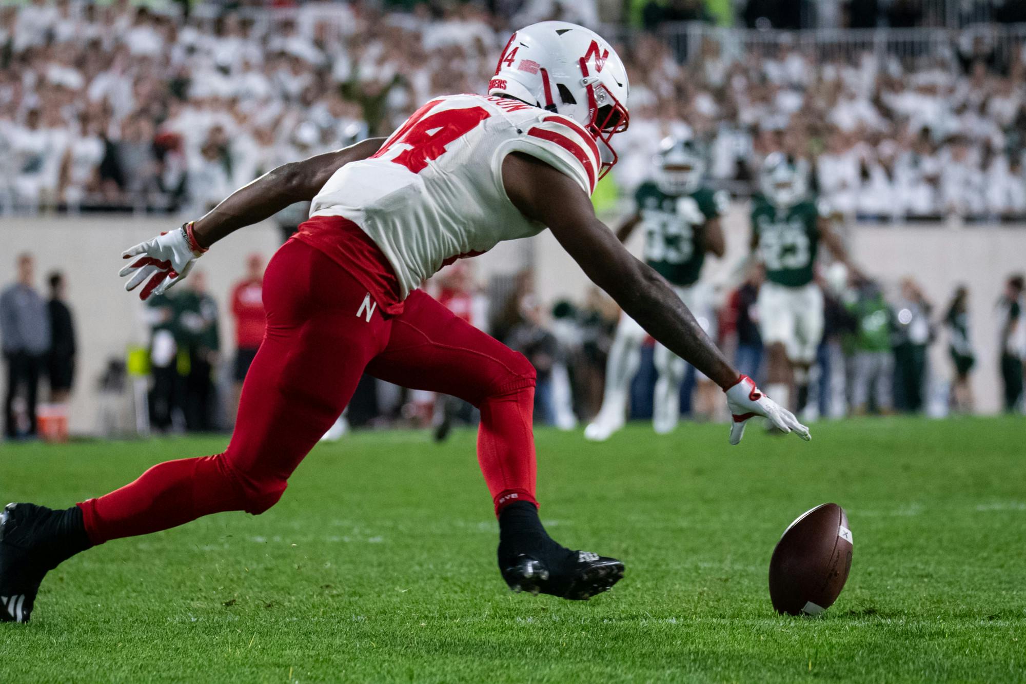 <p>Nebraska&#x27;s Rahmir Johnson (14) reaches for the ball during Michigan State&#x27;s win against University of Nebraska on Sept. 25, 2021.</p>