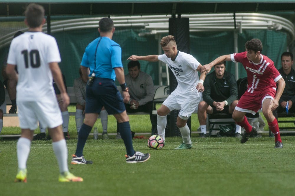 Sophomore forward Ryan Sierakowski (11) kicks the ball during the game against Wisconsin on Oct. 9, 2016 at Demartin Stadium. The Spartans tied the Badgers 01-01.