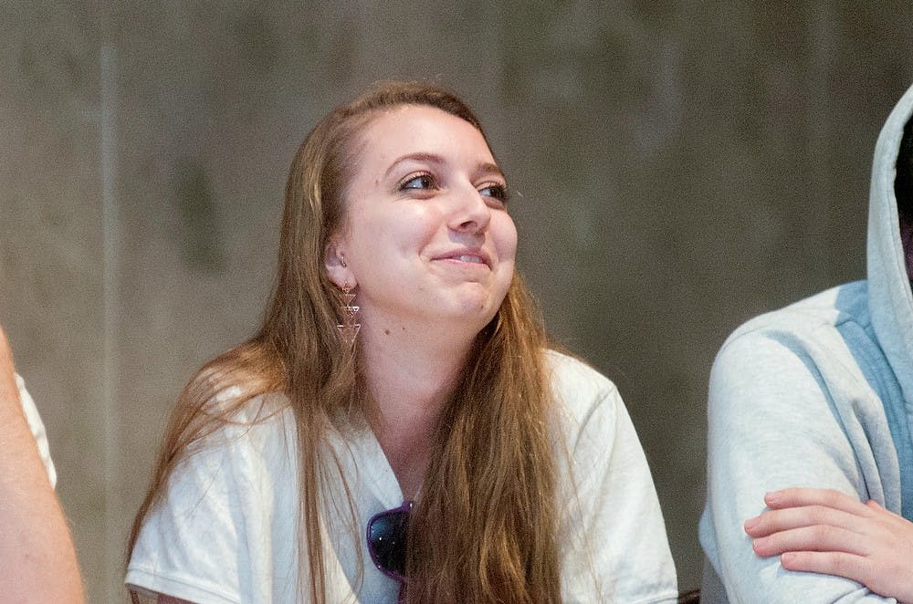 	<p>Psychology freshman Allison Hough answers questions along with several teammates to compete for prizes at the Spartan Family Feud event hosted by the University Activities Board in the Union Ballroom on Friday, Nov. 16, 2012. Several games were played throughout the night, and students continued to play when prizes ran out. Danyelle Morrow/The State News</p>