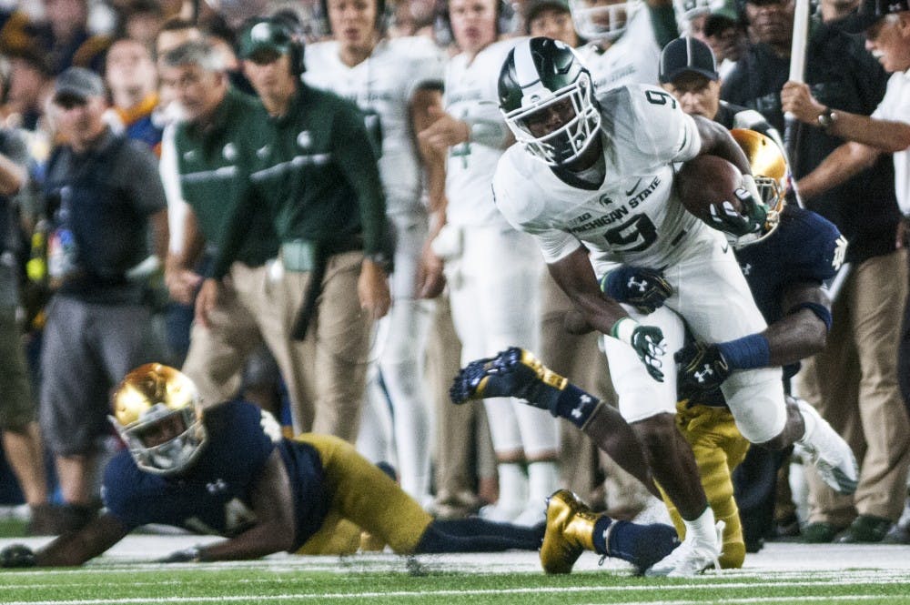 Freshman wide receiver Donnie Corley (9) breaks the tackle of Notre Dame safety Devin Studstill (14) during the game against Notre Dame on Sept. 17, 2016 at Notre Dame Stadium in South Bend, Ind.  The Spartans defeated the Fighting Irish, 36-28. 
