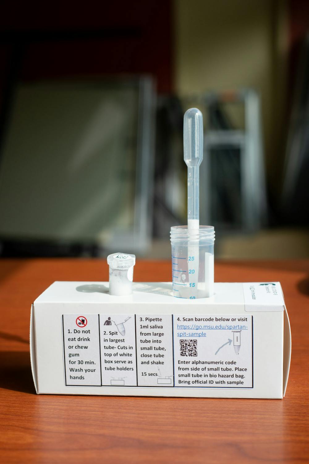 <p>After a spike in cases among students in East Lansing, President Samuel L. Stanley Jr. urged the students, faculty and staff to sign up for a COVID-19 early detection program called Spartan Spit. Elements of the Spartan Spit kit photographed above on Sept. 14, 2020.</p>