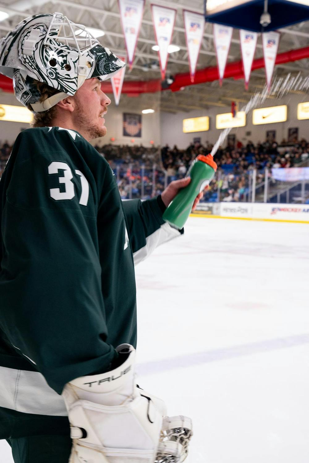 <p>Michigan State sophomore goaltender Luca Di Pasquo (31) checks the functionality of his water bottle during an exhibition game against the under-18 U.S. Men's National Team Development Program at USA Hockey Arena in Plymouth, Michigan on Nov. 21, 2024. In front of a sold out crowd, the Spartans captured a convincing 6-2 victory, showcasing why they deserve their ranking of number two in the nation.</p>