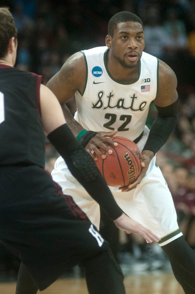 <p>Junior guard/forward Branden Dawson passes the ball while Harvard guard Laurent Rivard guards on March 22, 2014, at Spokane Veterans Memorial Arena in Spokane, Wash. during their game against Harvard in the NCAA Tournament. Dawson made 26 points during the game. Betsy Agosta/The State News</p>