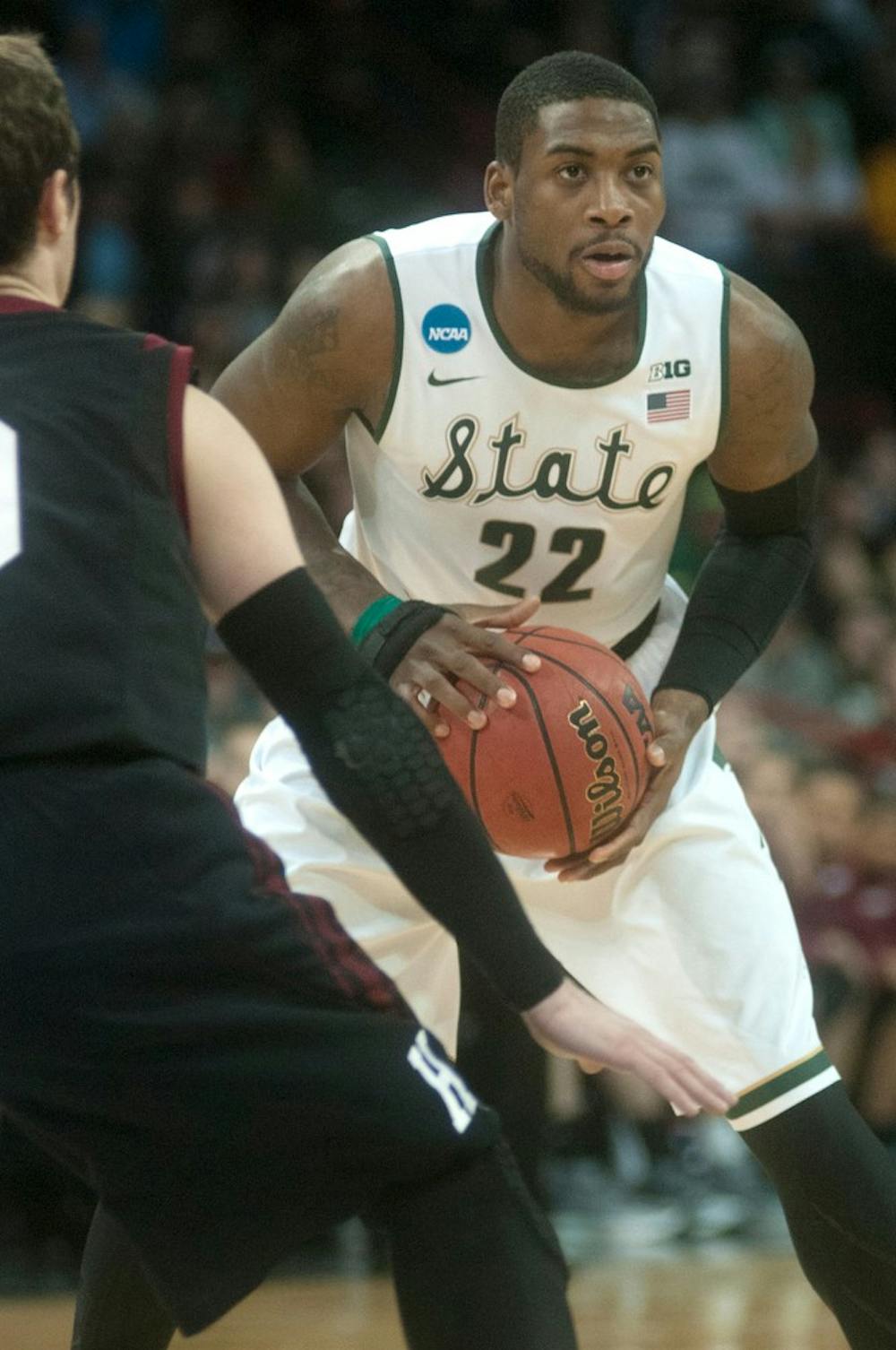 <p>Junior guard/forward Branden Dawson passes the ball while Harvard guard Laurent Rivard guards on March 22, 2014, at Spokane Veterans Memorial Arena in Spokane, Wash. during their game against Harvard in the NCAA Tournament. Dawson made 26 points during the game. Betsy Agosta/The State News</p>