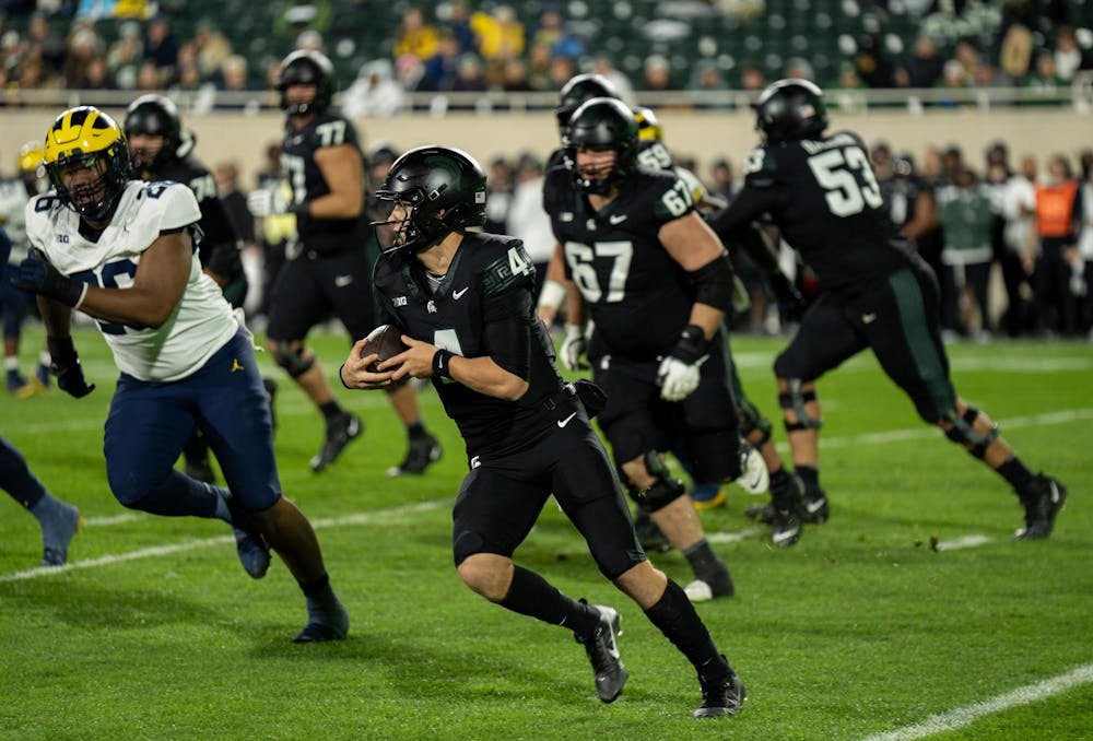 <p>Michigan State freshman quarterback Sam Leavitt (4) runs the ball during the second half of the game against University of Michigan at Spartan Stadium on Oct. 21, 2023.</p>