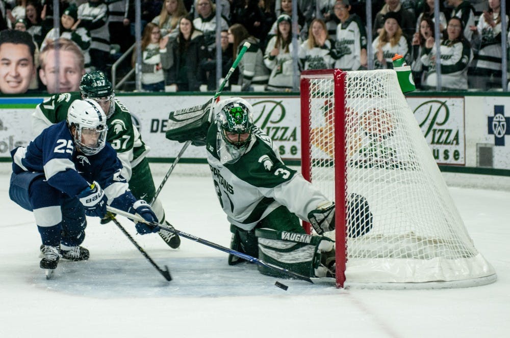 Junior goaltender John Lethemon (31) blocks a puck during the game against Penn State at Munn Ice Arena on Feb. 15, 2019. The Spartans defeated the Nittany Lions 5-3.