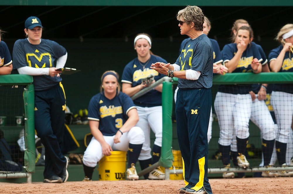 <p>Michigan softball head coach Carol Hutchins applauds players from the third base line during the game April 13, 2014, at Secchia Stadium at Old College Field. Hutchins was a 1979 graduate of Michigan State and part of the 1976 team that took the Spartans to the Association of Intercollegiate Athletics for Women National Softball Championship. Danyelle Morrow/The State News</p>